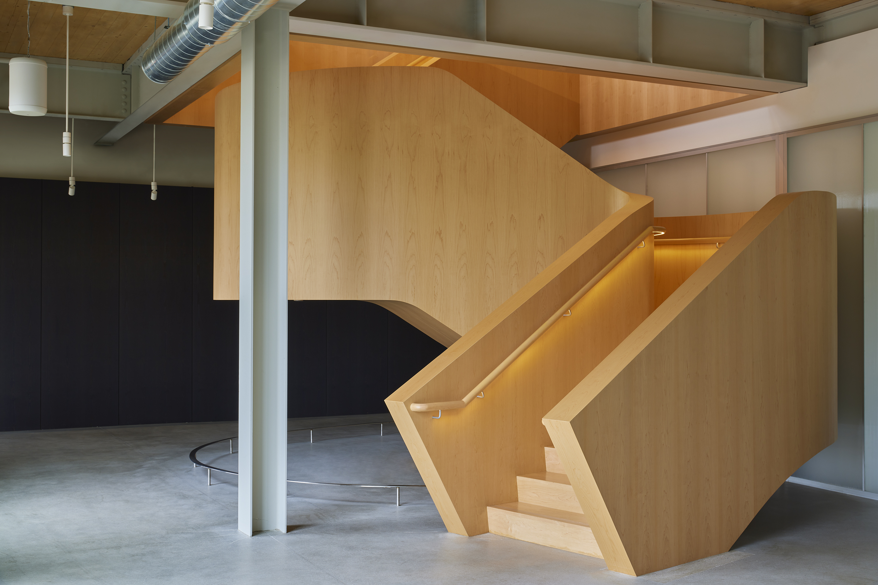 Maple stair flight with concealed lighting under a handrail