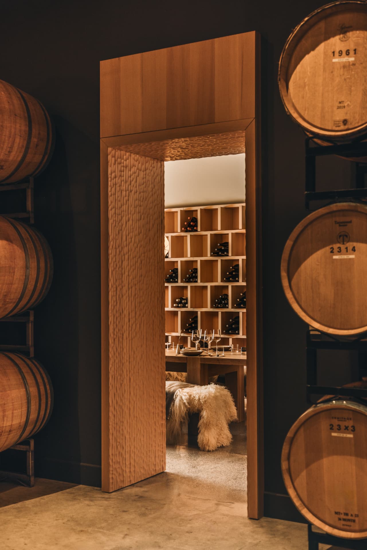 Carved timber door frame opening onto the tasting room