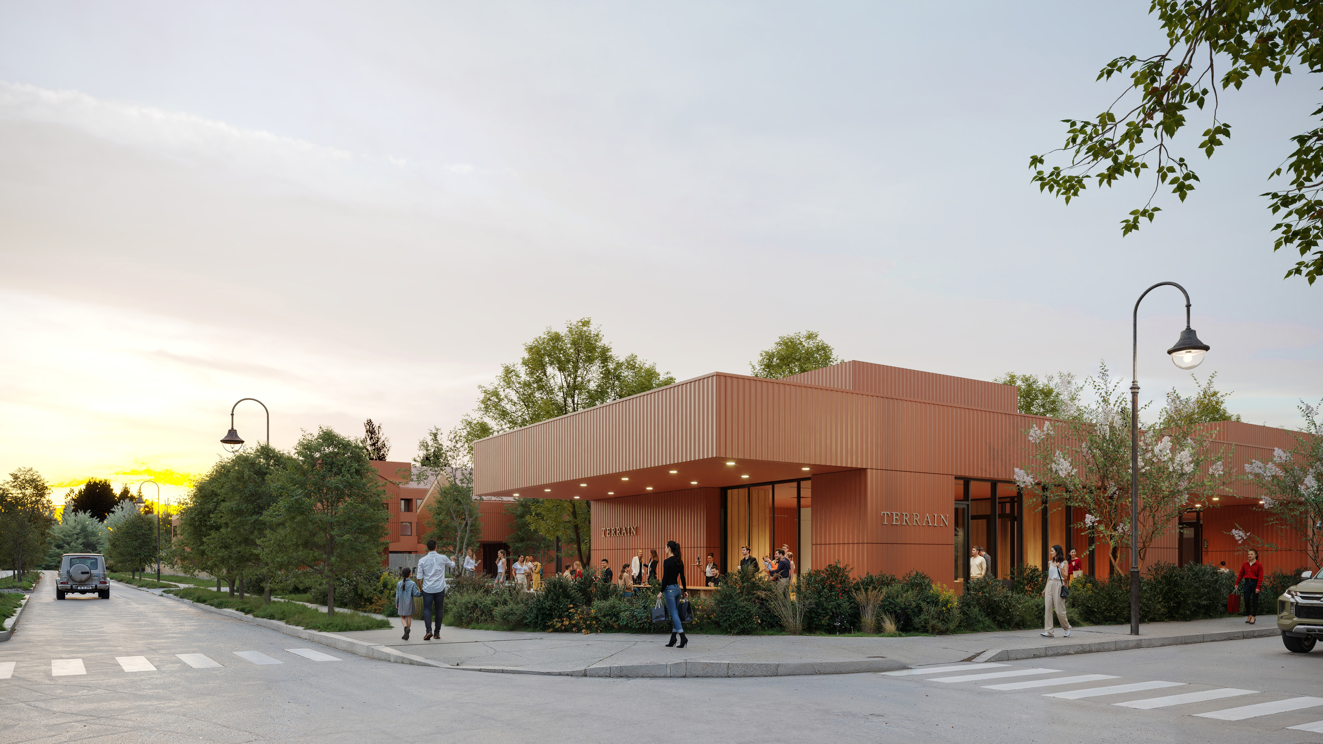 Terrain Hotel street-corner exterior at sunset with a low pavilion and copper-toned cladding