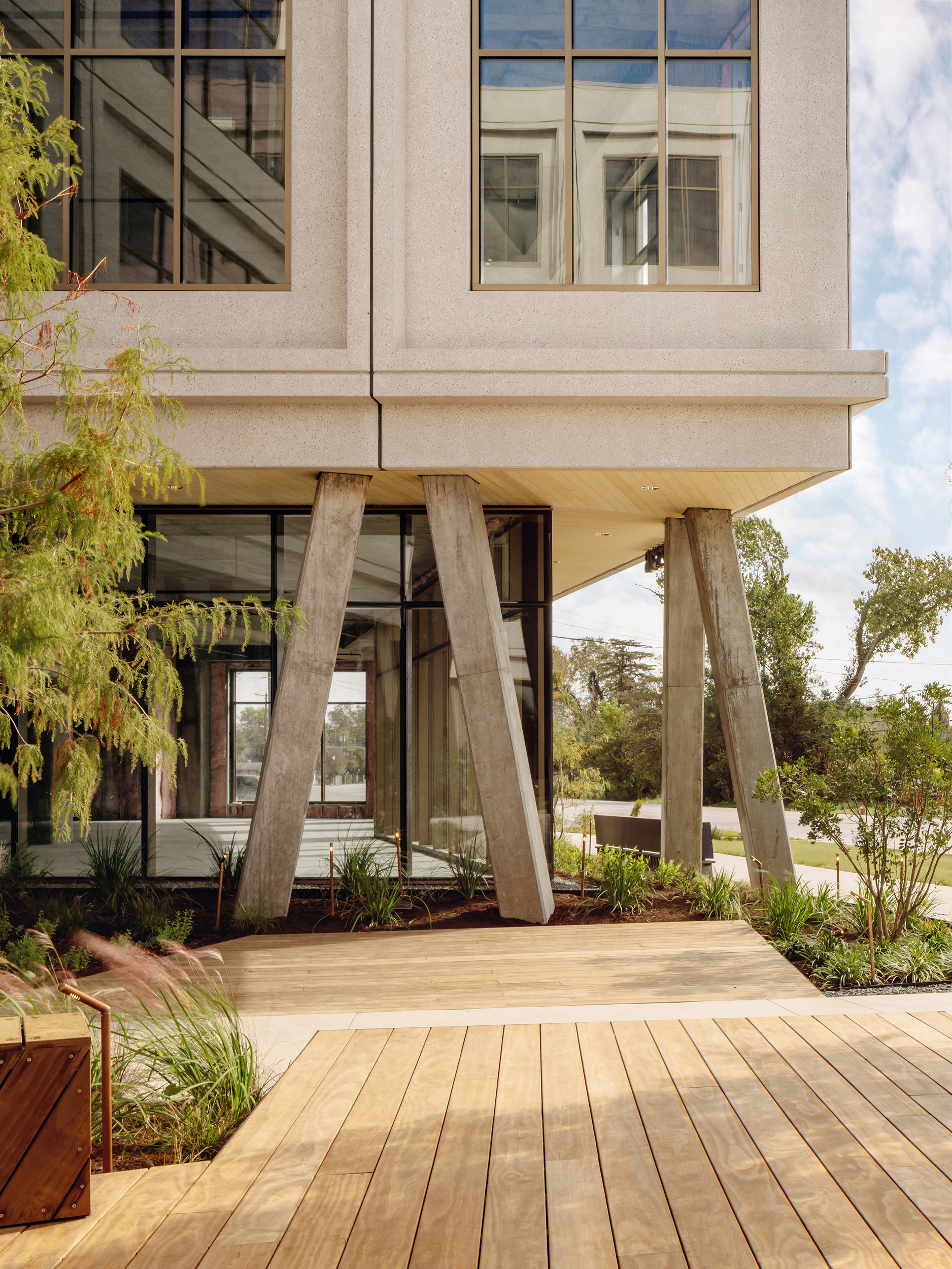 Low view of angled concrete columns supporting the building corner