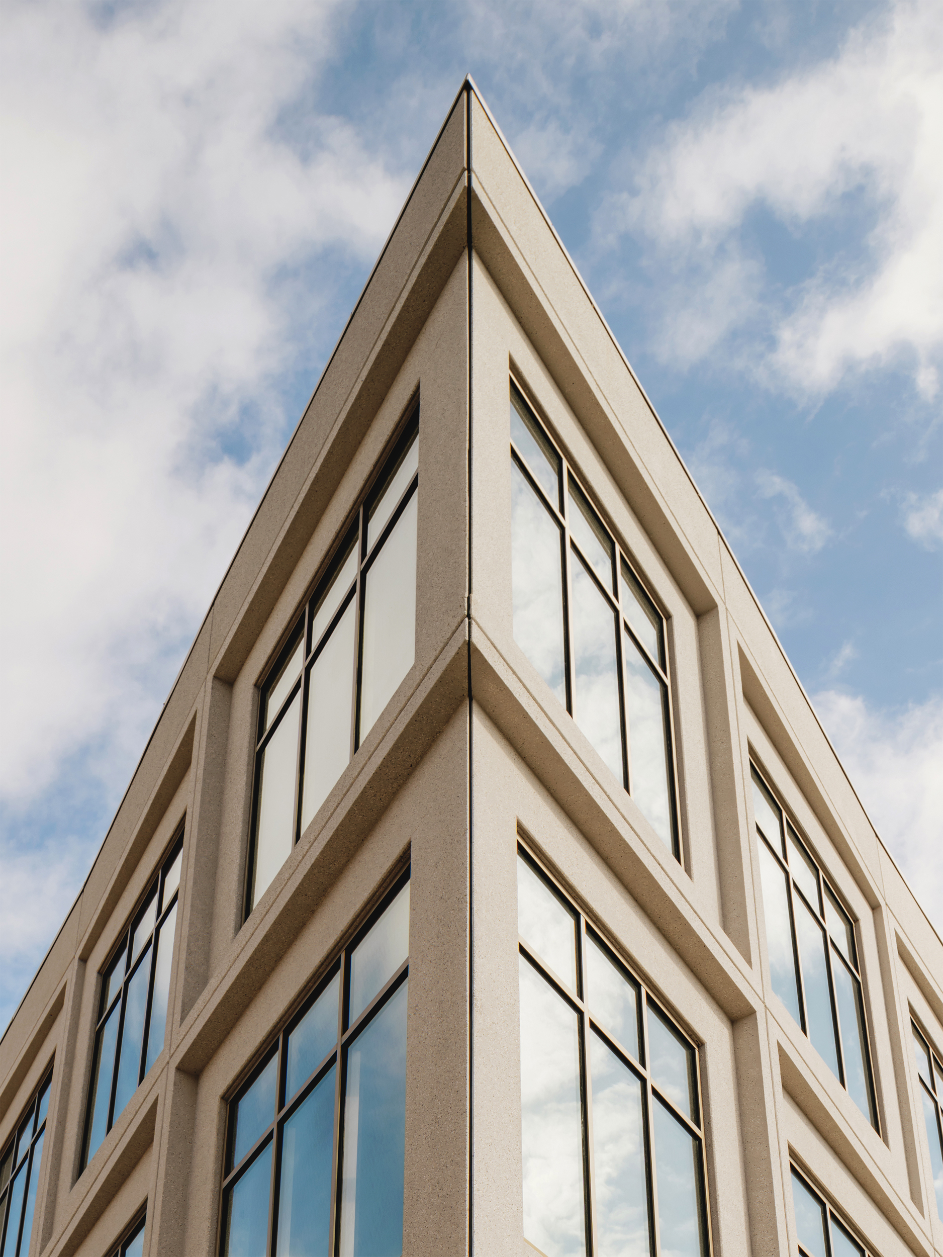 Upward view of the sharply framed building corner against the sky