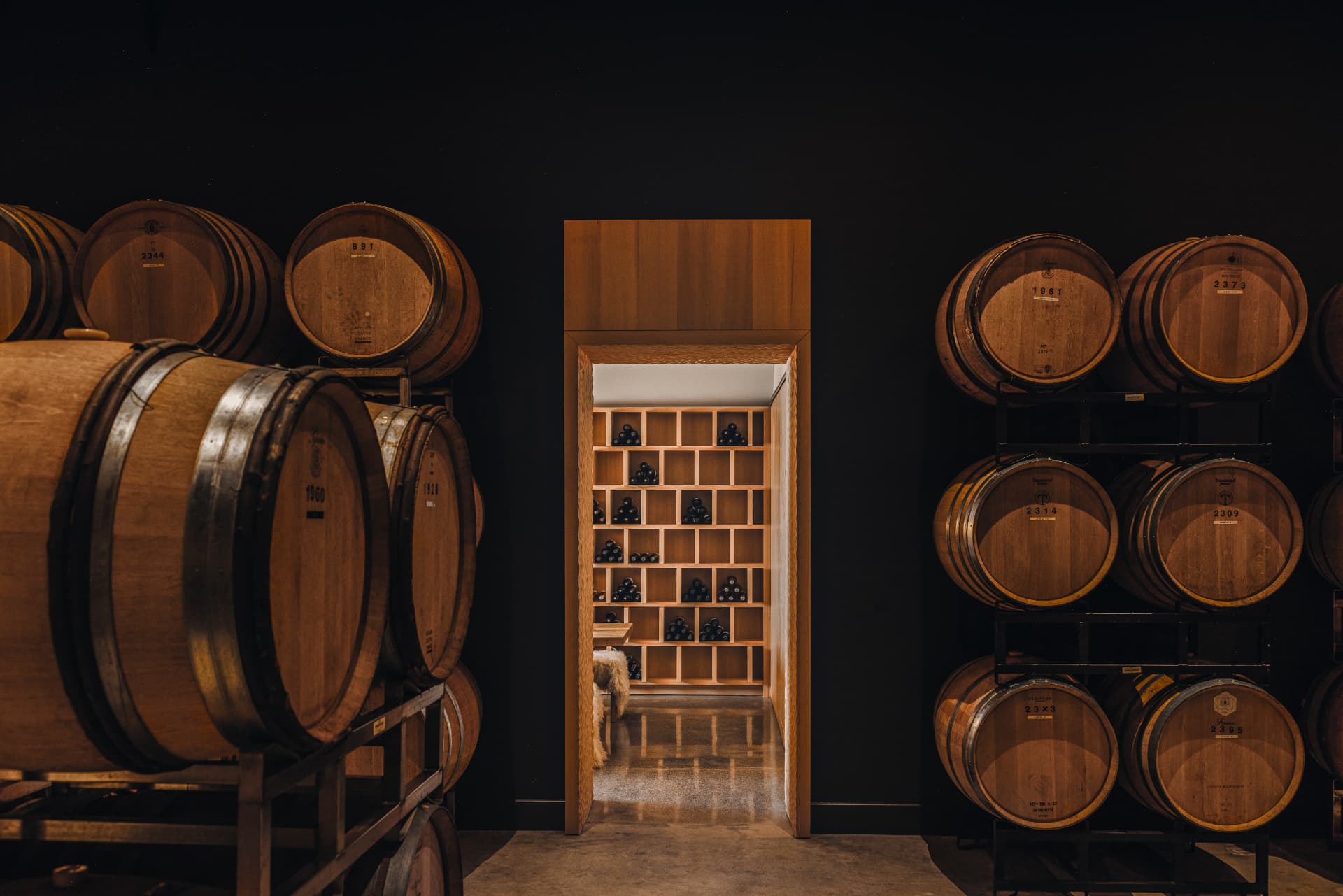 Doorway to the tasting room framed by stacked barrels