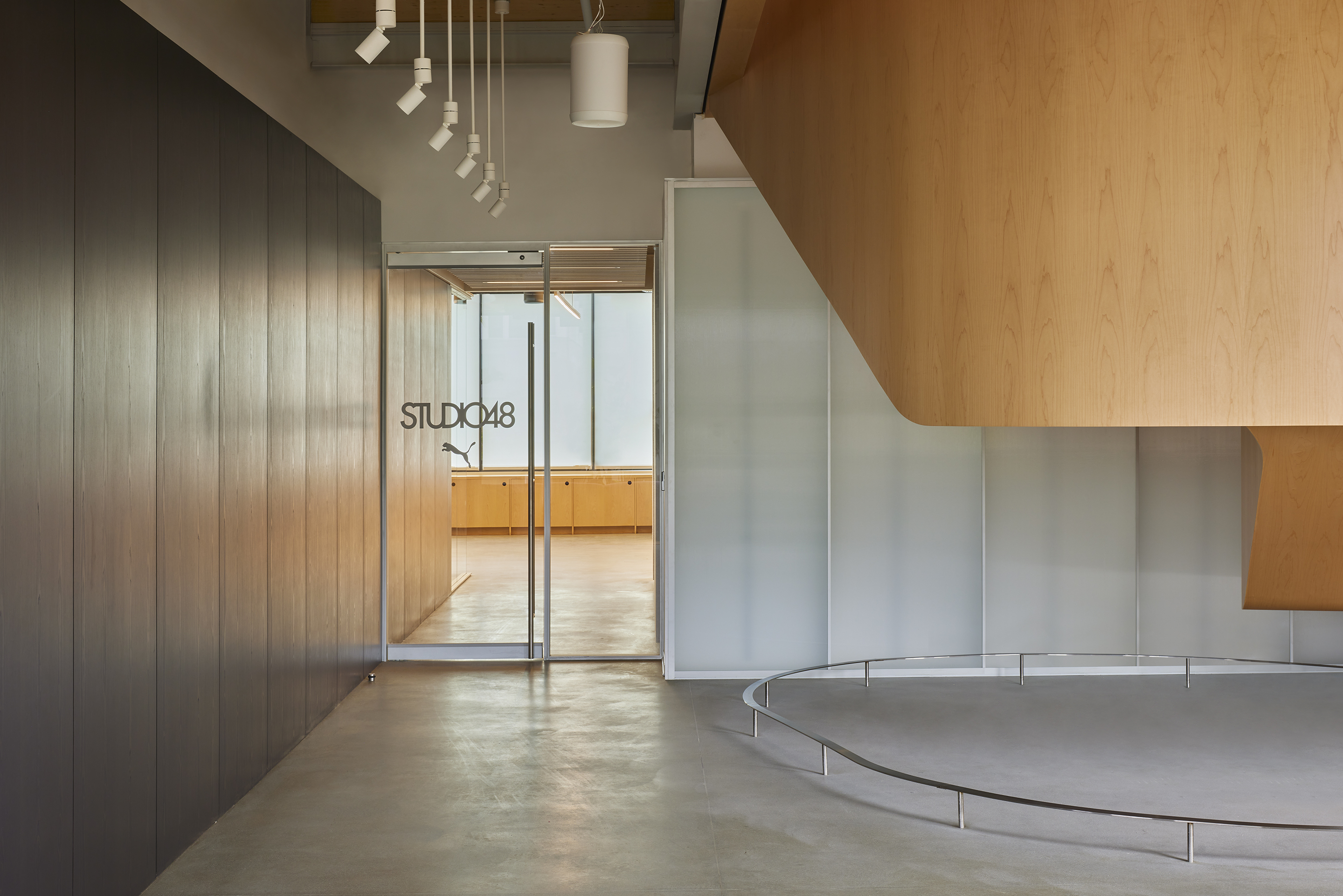 Timber-lined threshold with a glazed door to the studio beyond