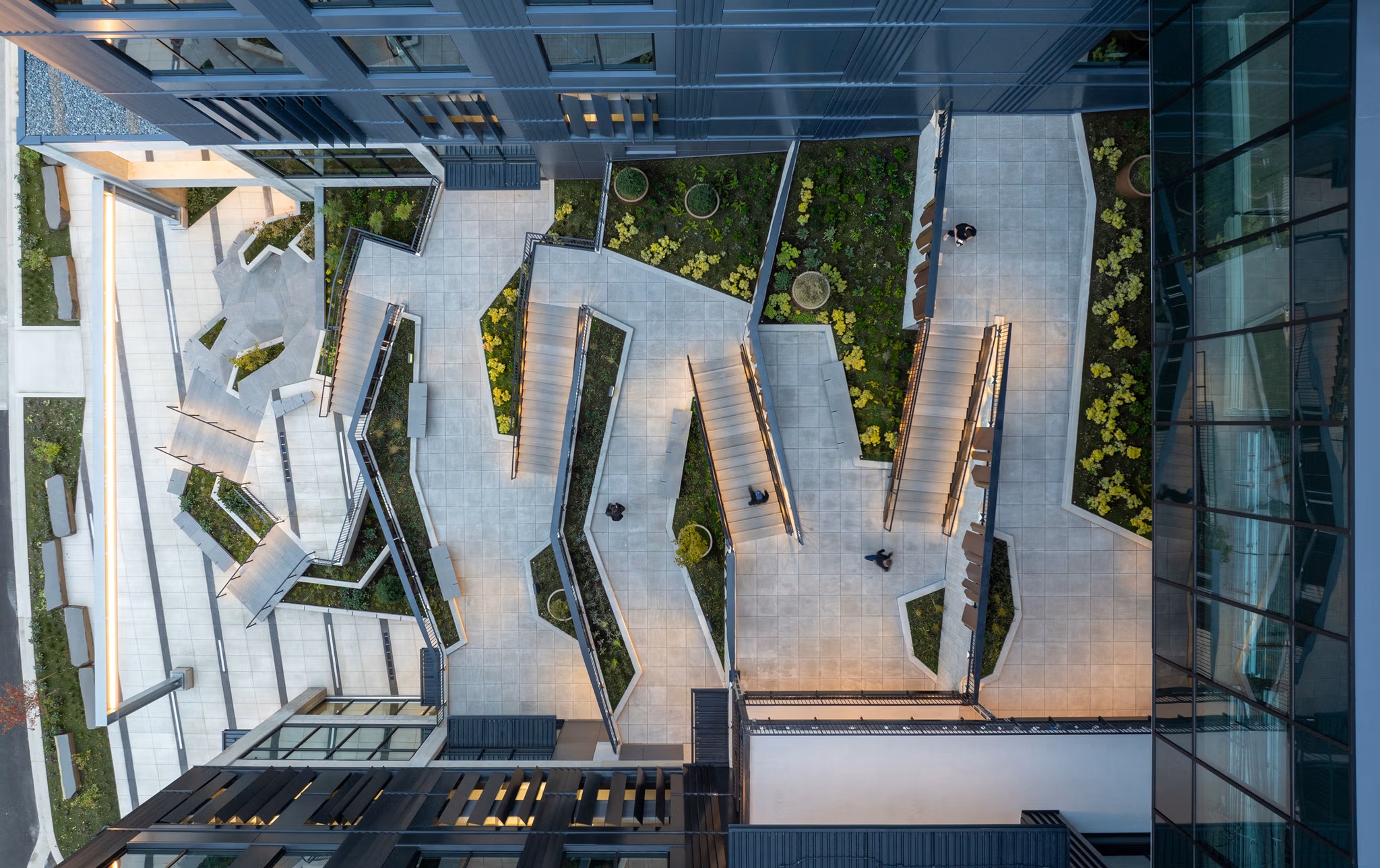 Overhead view of the courtyard's angular paving, planting beds and stairs
