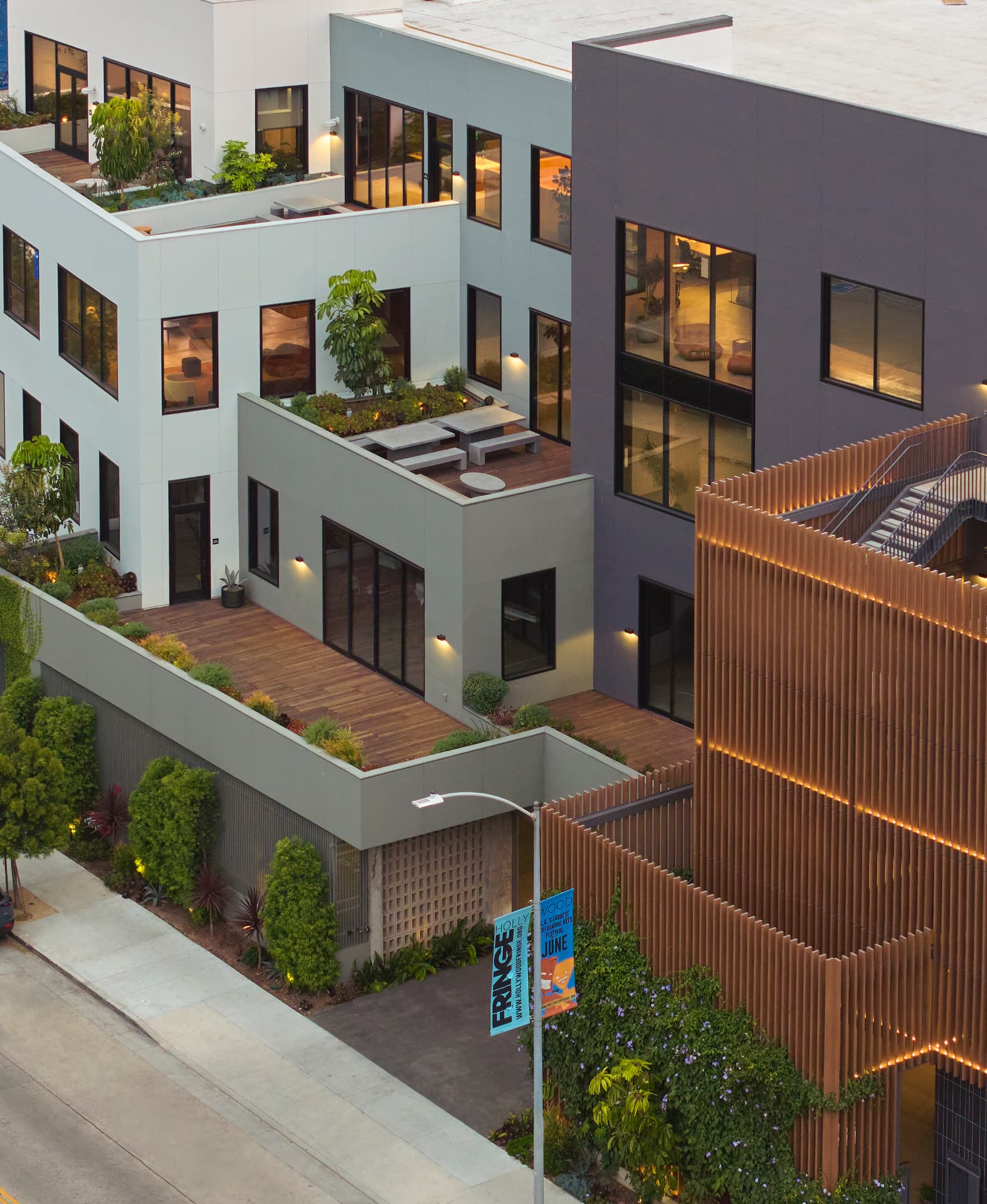 Aerial view of the building's terraces, planting and timber-screened volume